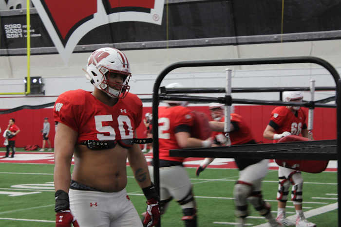 Wisconsin right tackle Logan Brown walking back after a rep during spring practice.